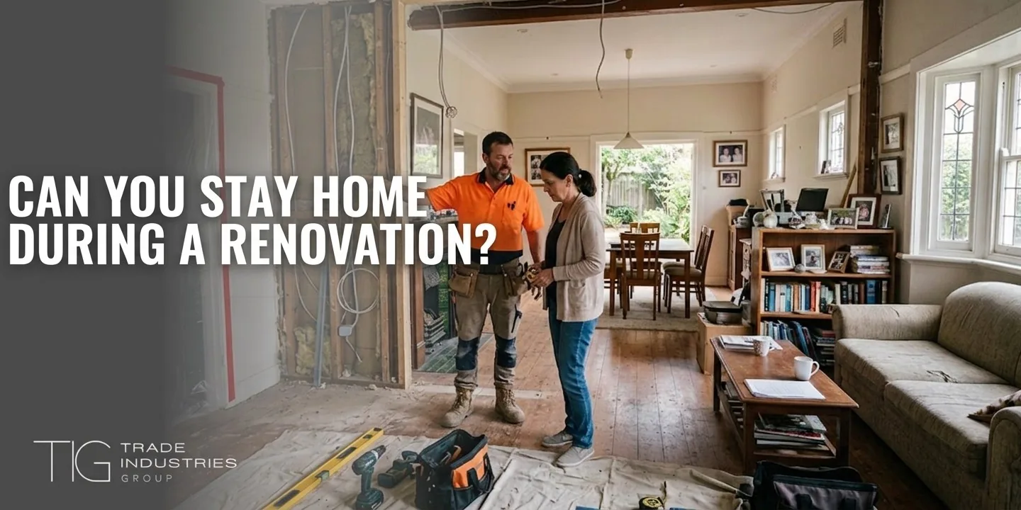 Living at Home During a Renovation: A Practical Guide for Sydney Homeowners 8 Sydney homeowner talking with a tradesperson beside an opened-up wall while still living at home during a renovation