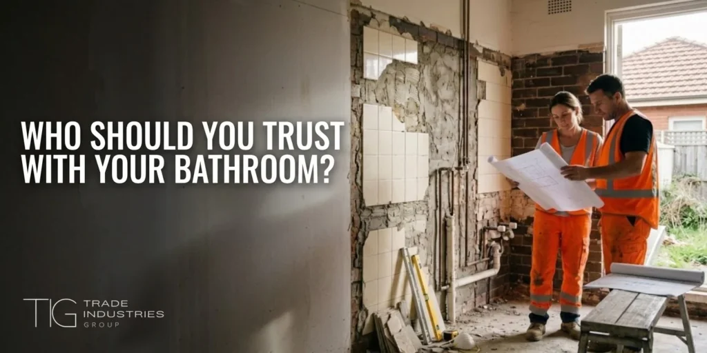 Fixed Price Renovation Contract Sydney: What to Check Before You Sign 7 Two workers in hi-vis reviewing plans in a stripped-back Sydney bathroom